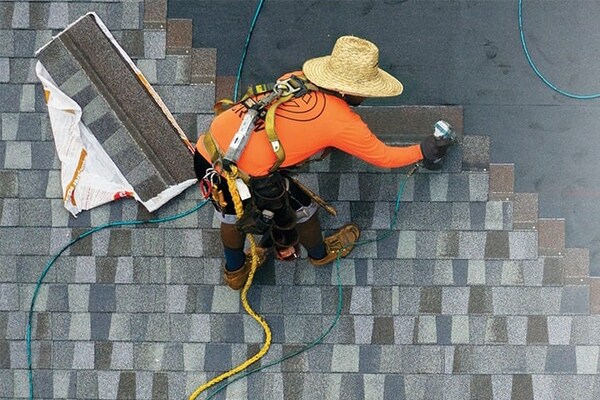 Roofing contractor nailing GAF roof shingles