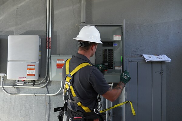 A technician from GAF Energy Services works on an electrical installation as part of support offered to home builders and developers. 