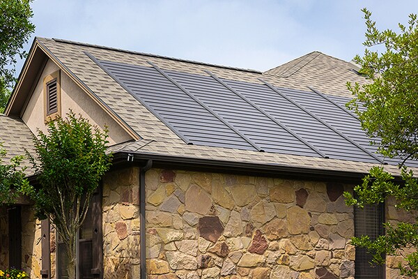 Sideview of a gray roof with  GAF Energy Timberline Sola panels.