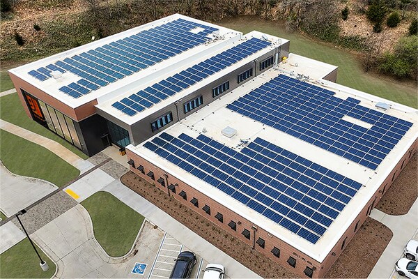 Large commercial building with rows of solar panels on the roof