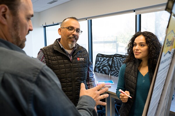 Latino roofing contractors engaging with GAF CARE roofer training center