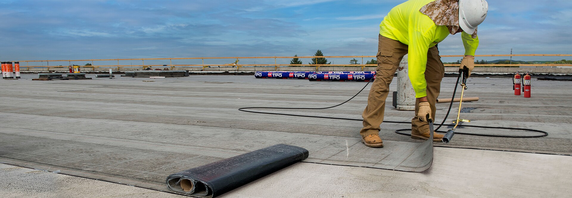 A contractor on a roof installing a hybrid system