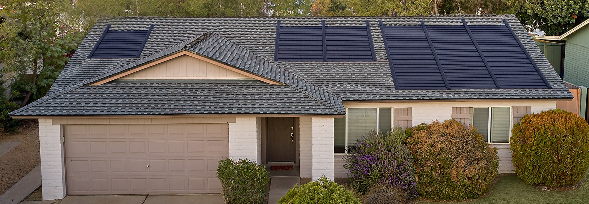 Aerial view of a Timberline Solar Roof System on a house