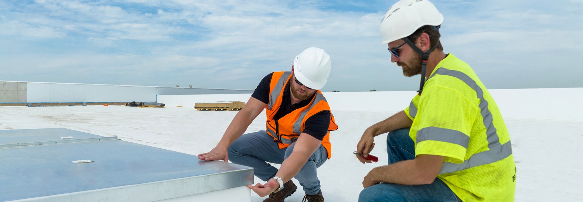 Commercial roofing contractors on a flat roof